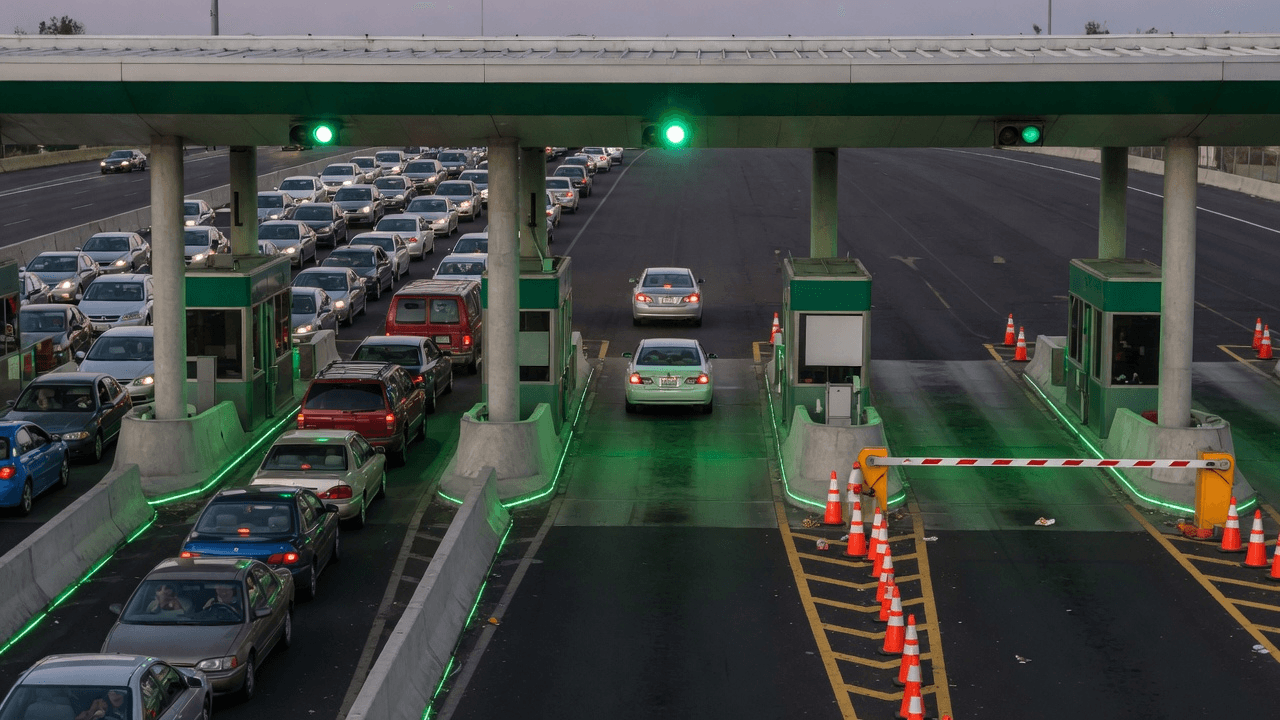 A highway toll plaza packed at green lights on Thursday, two cars rolling through Friday, Monday barrier down for the holiday